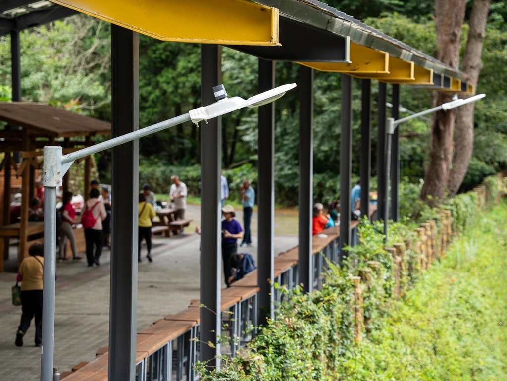 LED luminaires along a covered forest walkway at Baxianshan National Forest Recreation Area